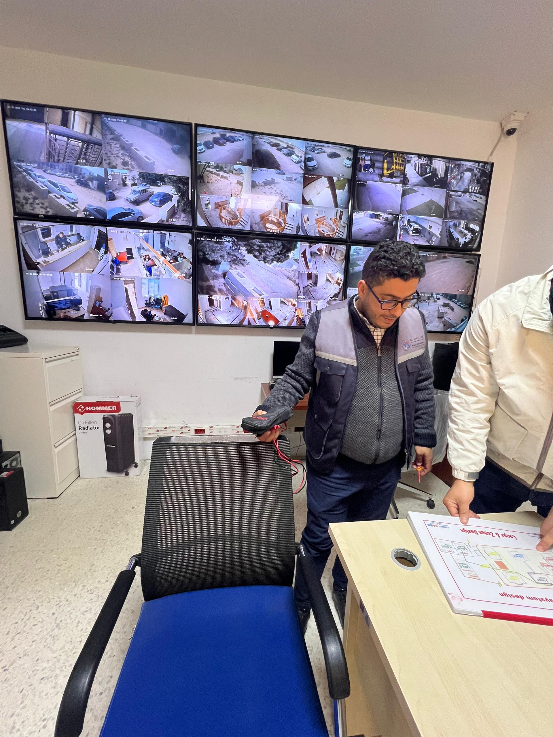 Operational monitoring room with multi-screen surveillance wall